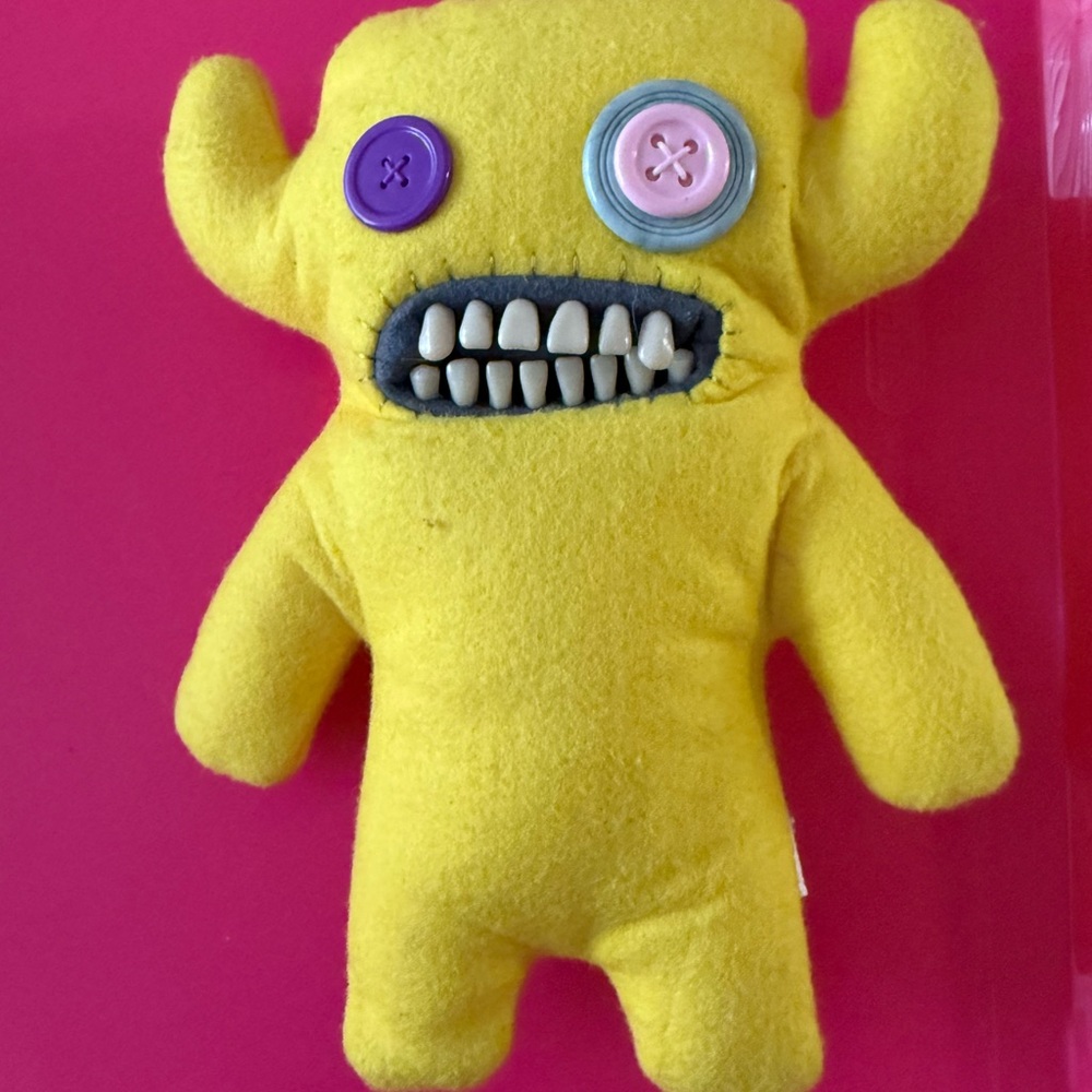 Yellow and Purple Stuffed Animal with Quirky Design